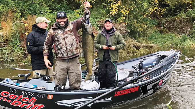 Jan Hrdlicka (front center) holds a Chinook salmon on the Oswego River. Looking on are Olaf Jochmann, back left and Capt. Kevin Davis, right. Photos courtesy of Catch the Drift and Chasin' Tail Adventures guide services.